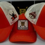 Hattrix Own Thw Game - Orange Trucker cap